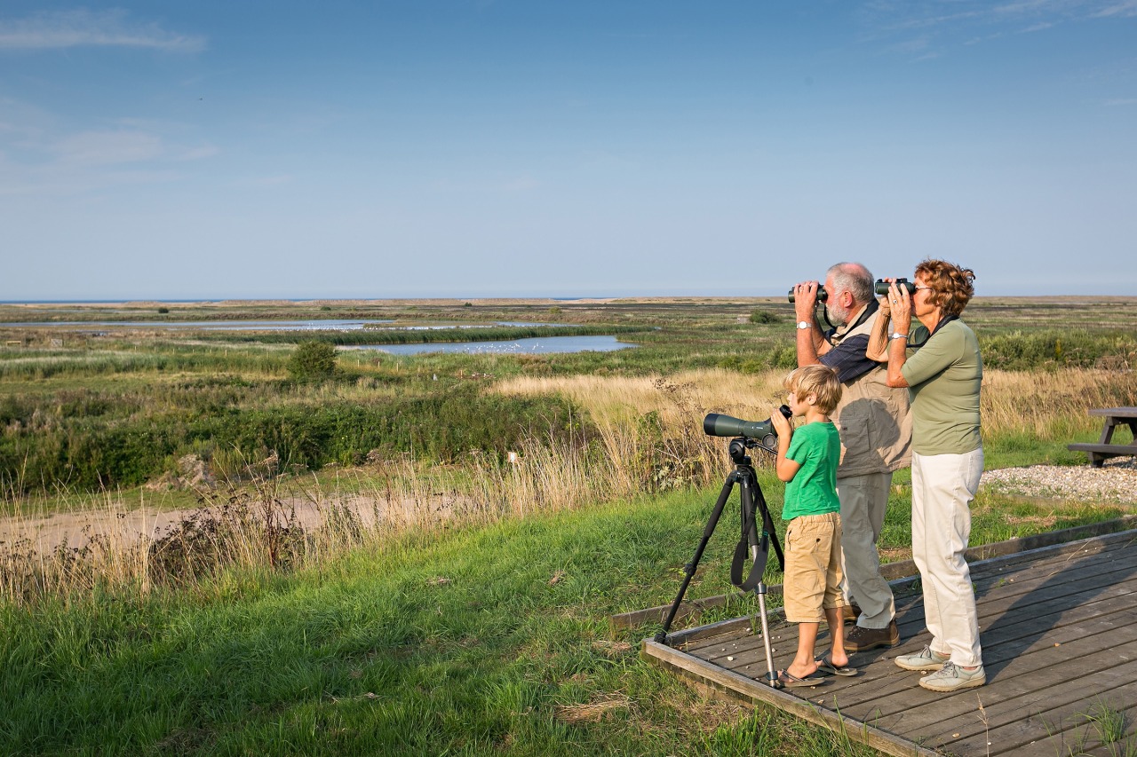 Older couple and child at a birdwatching platform. Norfolk Coast Partnership.